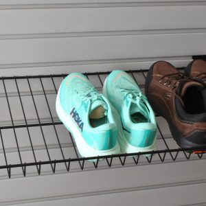A Slatwall Snap-Latch shoe shelf with shoes staged on top.